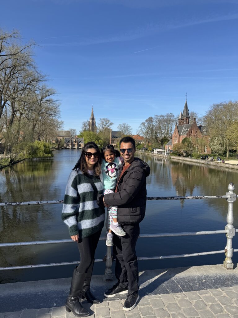 a husband and wife and their daughter taking a picture