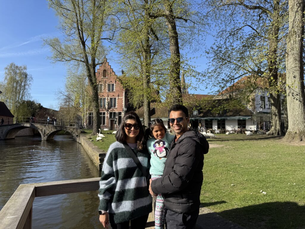a husband and wife and their daughter taking a picture