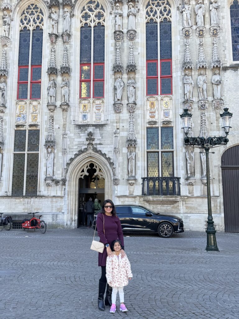 daughter and wife taking a picture of a building