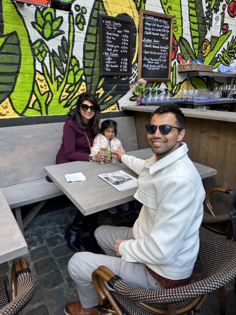 a wife and husband with their daughter taking a picture