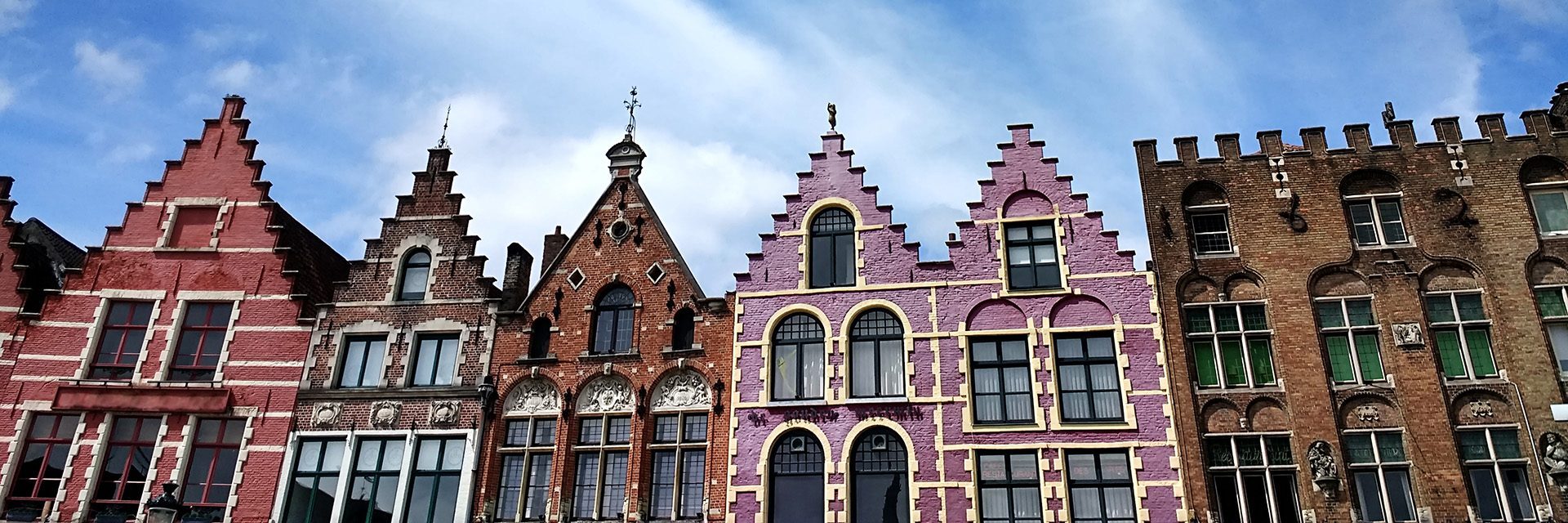The Grote Markt under a blue sky and sunlight in Bruges in Belgium