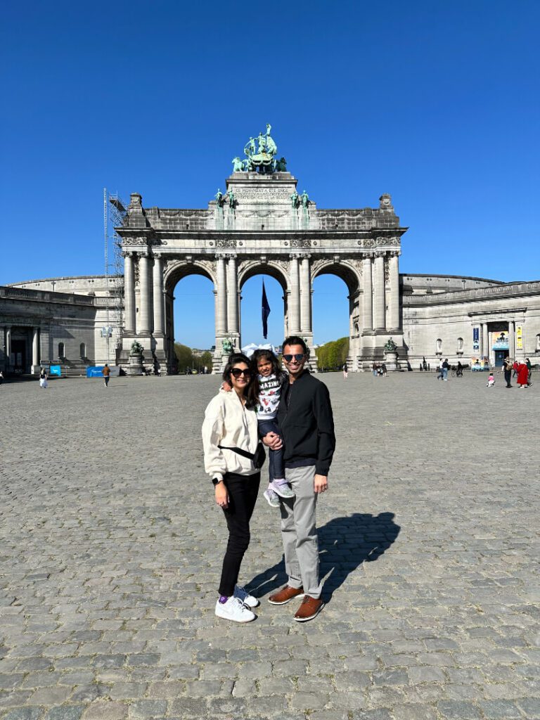 a husband and wife and their daughter taking a picture